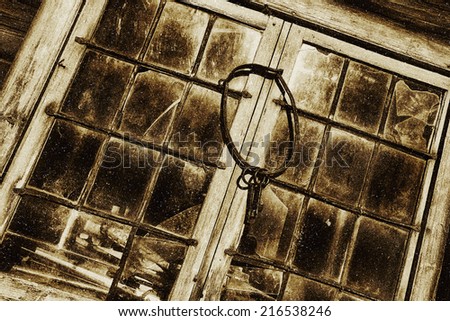 antique keys hanging from old stained glass and leaded window frames, toning idea