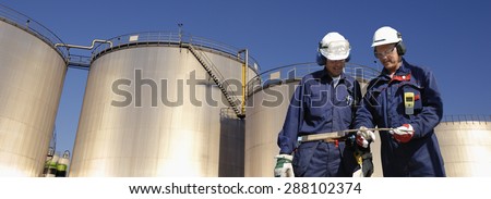 refinery workers, oil and fuel towers, panoramic view