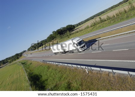 clean white lorry speeding along on highway in the country