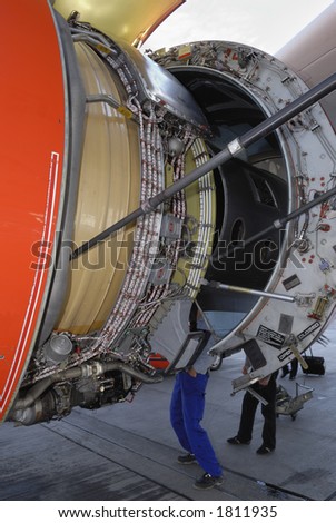 stock photo : close-up of engineers servicing large jet-engine