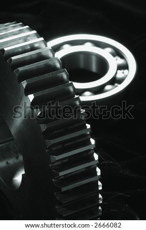 large gear and bearing ( blurry) a lighting-idea against black-velvet