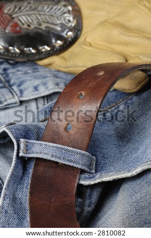 jeans, denim with leather belt and buckle and leather gloves