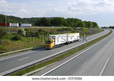 clean white truck on highway surrounded by countryside