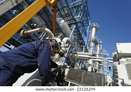 engineer working inside large oil and gas refinery, chemical plant.