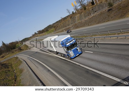 large truck on the go, scenic highway, elevated view from above, trademarks removed