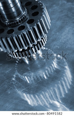 new aerospace titanium gears, wheels, mirrored in steel background