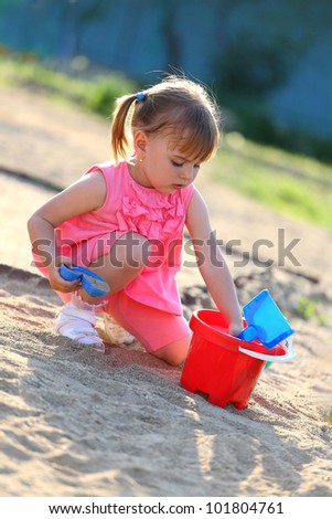 Girl playing in the sandpit