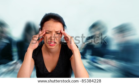Woman heaving a headache during a staff meeting
