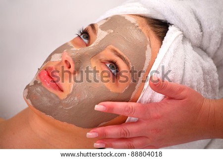 Spa clay mask on a woman\'s face, white background