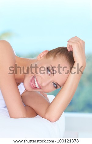 Closeup facial expression of a beautiful high-spirited woman laughing into the camera