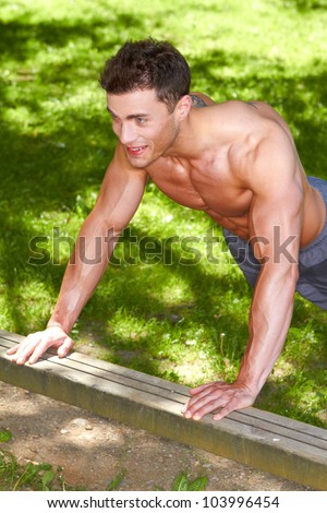 Well build man train in park at summer time