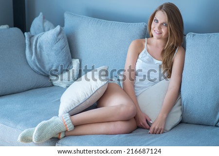 Portrait of Young Woman Wearing Socks and Underwear Sitting on Sofa