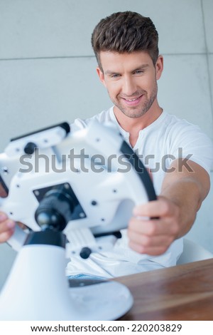 Close up Happy Handsome Middle Age Man Playing Cool Modern Gadget on Table