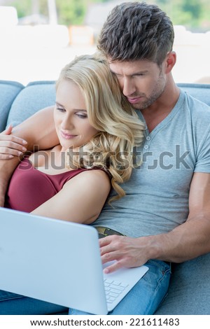 Close up Sweet Middle Age White Couple Watching Movie Through Laptop at Home Couch