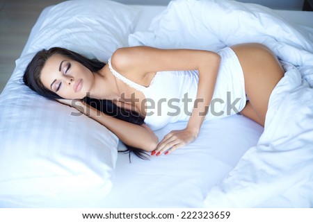 Sleeping Positions. Young Woman In White Underwear Sleeping On A