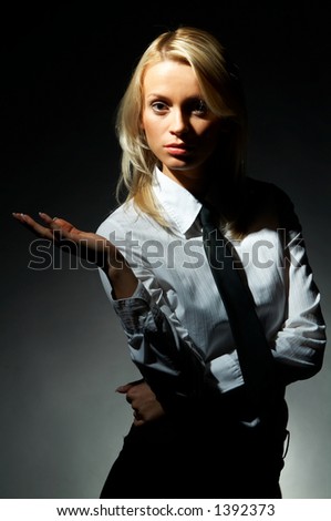 Blond model, business woman pose on black background