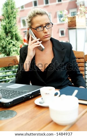 Business women working with laptop computer and talking cell phone