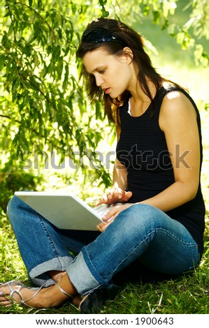 Beautiful woman with laptop computer on autumn outdoor
