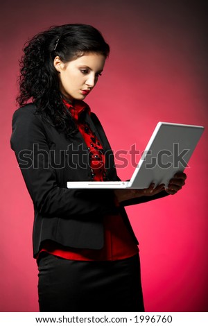 Young Business woman wearing red shirt and black jacket with laptop computer
