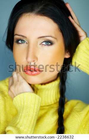 Portrait of beautiful woman wearing yellow sweater