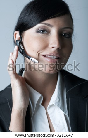 Beautiful and sexy brunette business woman talking telephone. She is isolated on clear background