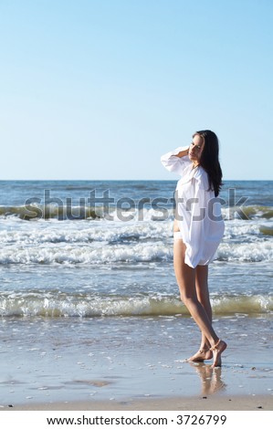 20-25 years old Beautiful Woman on the beach, wearing shirt