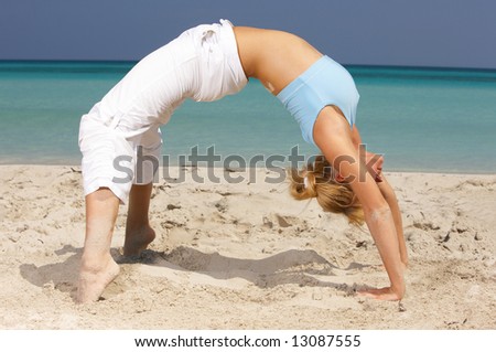Young beautiful woman during fitness on sea beach