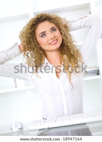 Beautiful business woman is stretching in office