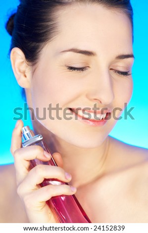 Portrait of 20-25 years old beautiful woman with bottle of perfume