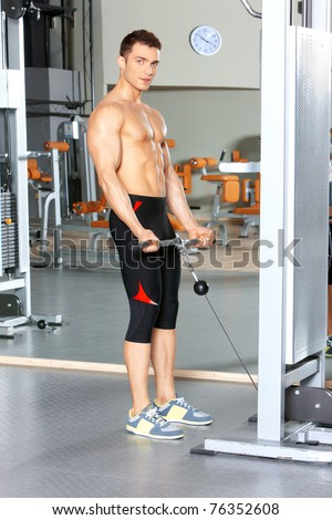 Handsome man at the gym doing exercises