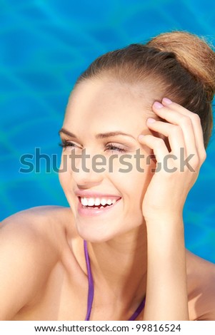 Close up of young adorable woman in swimming pool