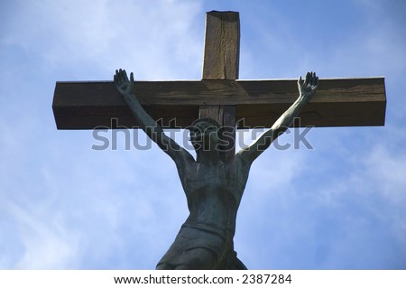 Closeup of Jesus on the cross. On a blue background