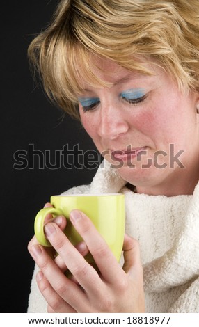 Beautiful girl drinking hot coffee, it\'s getting colder.