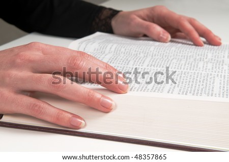 Woman\'s hands on a Bible, studying and reading.