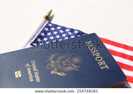 A horizontal image of an American passport on an American flag