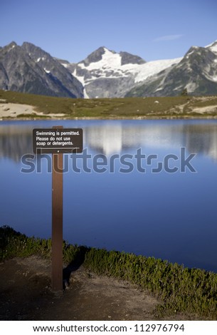A sign asks people to refrain from polluting the alpine lake with soap or detergents