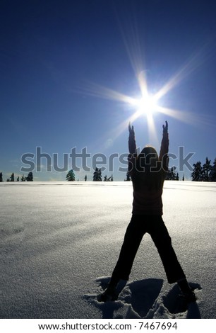 A woman worships the warmth of the sun on a cold winter day.
