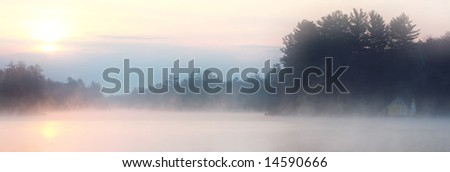 Dawn mist over a lake in Old Forge, New York