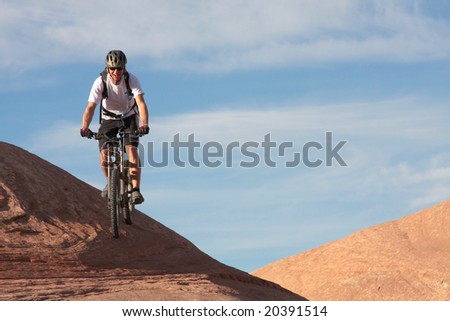A smiling rider on Moab's famous slickrock trail.