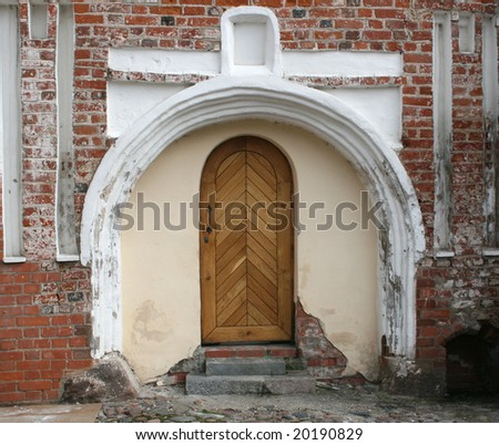 Gothic detail - portal (with doors) and red brick wall