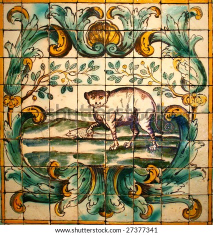 hand made mosaic from colorful tiles in Lisbon Azulejos museum (cat holding mouse)