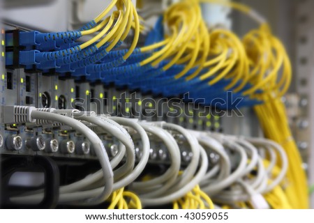 Media Converters. Fiber Optic cables connected to an optic ports and UTP Network cables connected to an Fast/Giga ethernet ports. Data Network Hardware Concept. SC/UPC connectors.