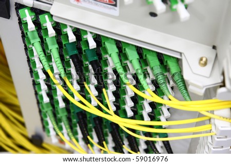 Fiber Optics with SC/APC connectors - Patch Panel. Internet Service Provider equipment. Focus on fiber optic cables. Data Network Hardware Concept.