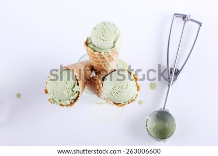 green tea ice cream cones in clear glasses on white background