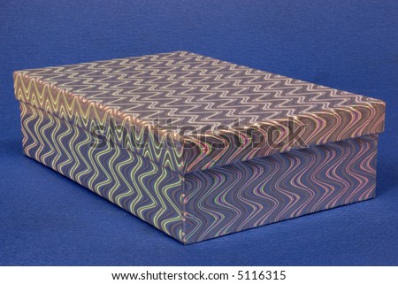Silver coloured gift box with a multi coloured rainbow effect pattern