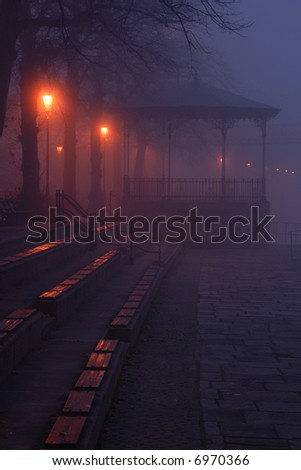 Deserted bandstand at night surrounded by fog by the river Dee in Chester UK