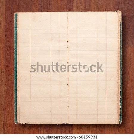 Old note book open blank page on wood background
