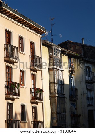 Old houses and moon in daylight in Vitoria, Basque Country, Spain