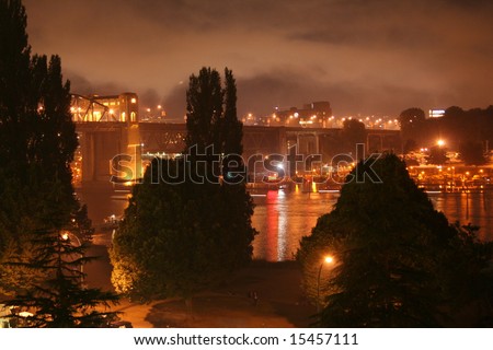 burrard bridge at night with moving boats