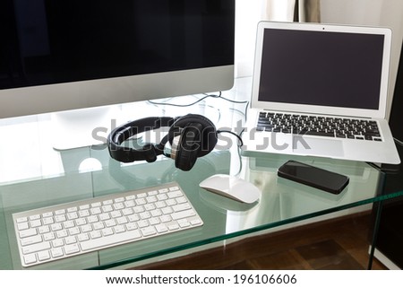 Modern home office with computer and laptop